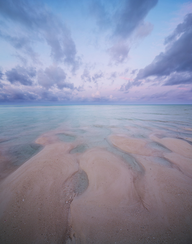 The sky and sand mirror each other during a pastel sunrise. &nbsp;